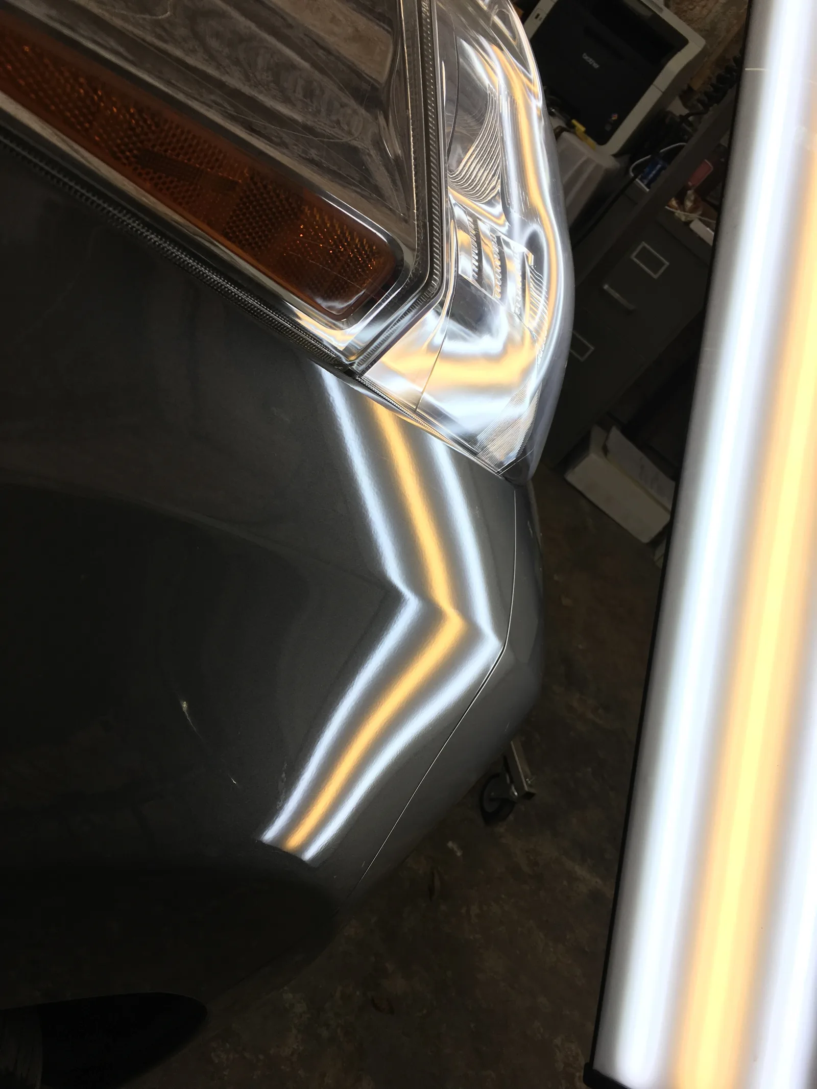 After PDR repair — gray vehicle fender fully restored near headlight